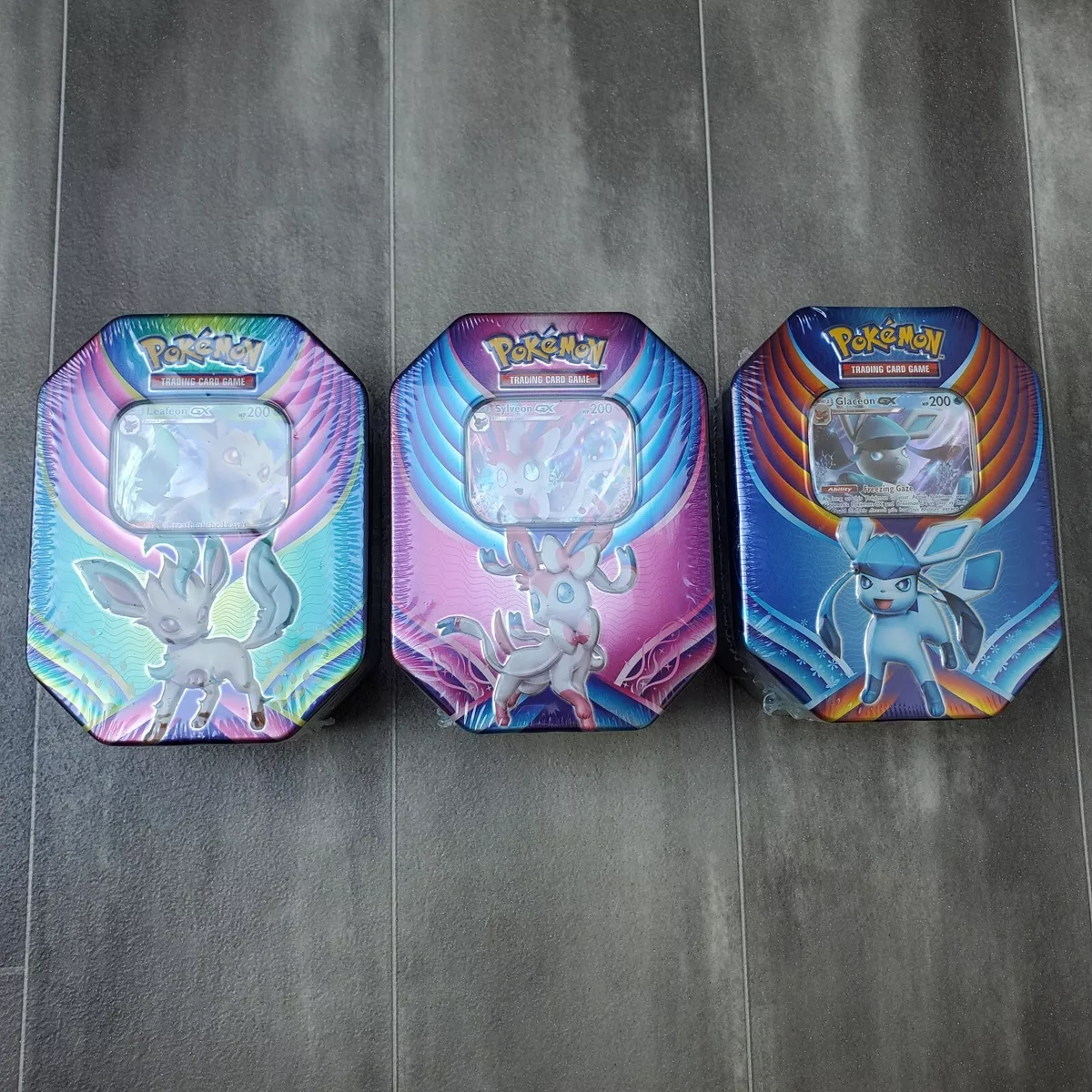 Pokémon TCG: Evolution Celebration Tin (Leafeon-GX) and 1 of 6