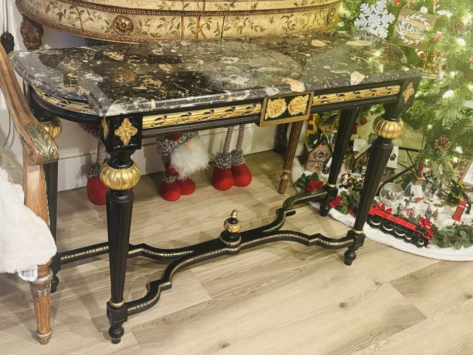 A black lacquered console table with marble top and gold gilt accents. - Image 2 of 4