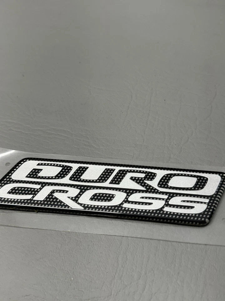 Mitsubishi Raider Duro 2006-2009 emblema de puerta lateral cruzada logotipo insignia usado fabricante original Foto 3 de 4