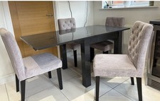 A 4 Seater Next Extendable dining table in a black -Gloss finish with 4 Chairs