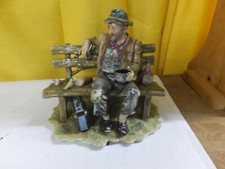 Natures Nobleman figurine - man sitting on park bench eating with birds