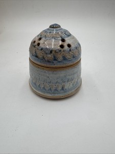 studio art pottery garlic keeper or jar designed with ventilation holes.