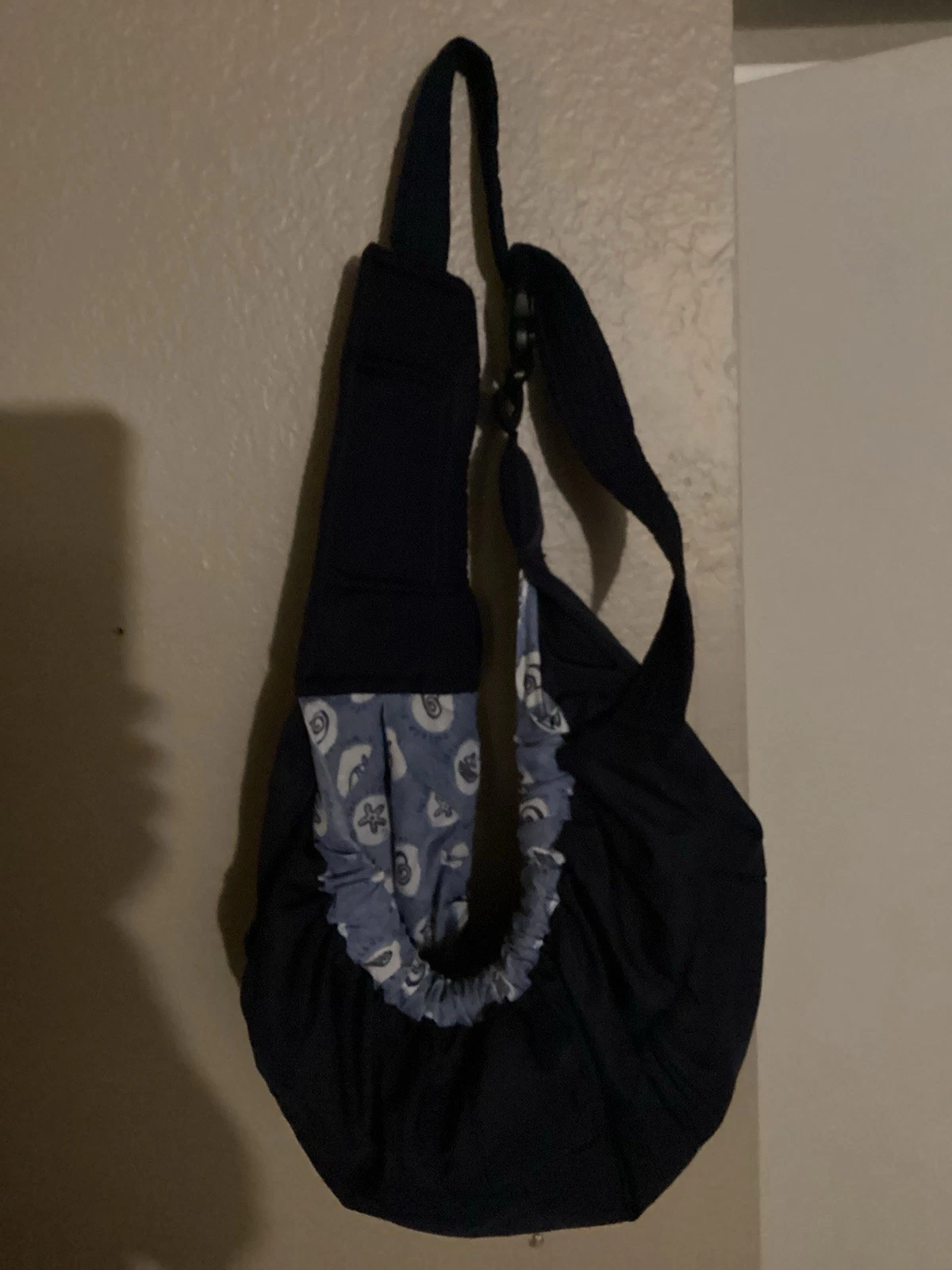 Baby carrier (or Small Dog) with a light blue and white nautical pattern.