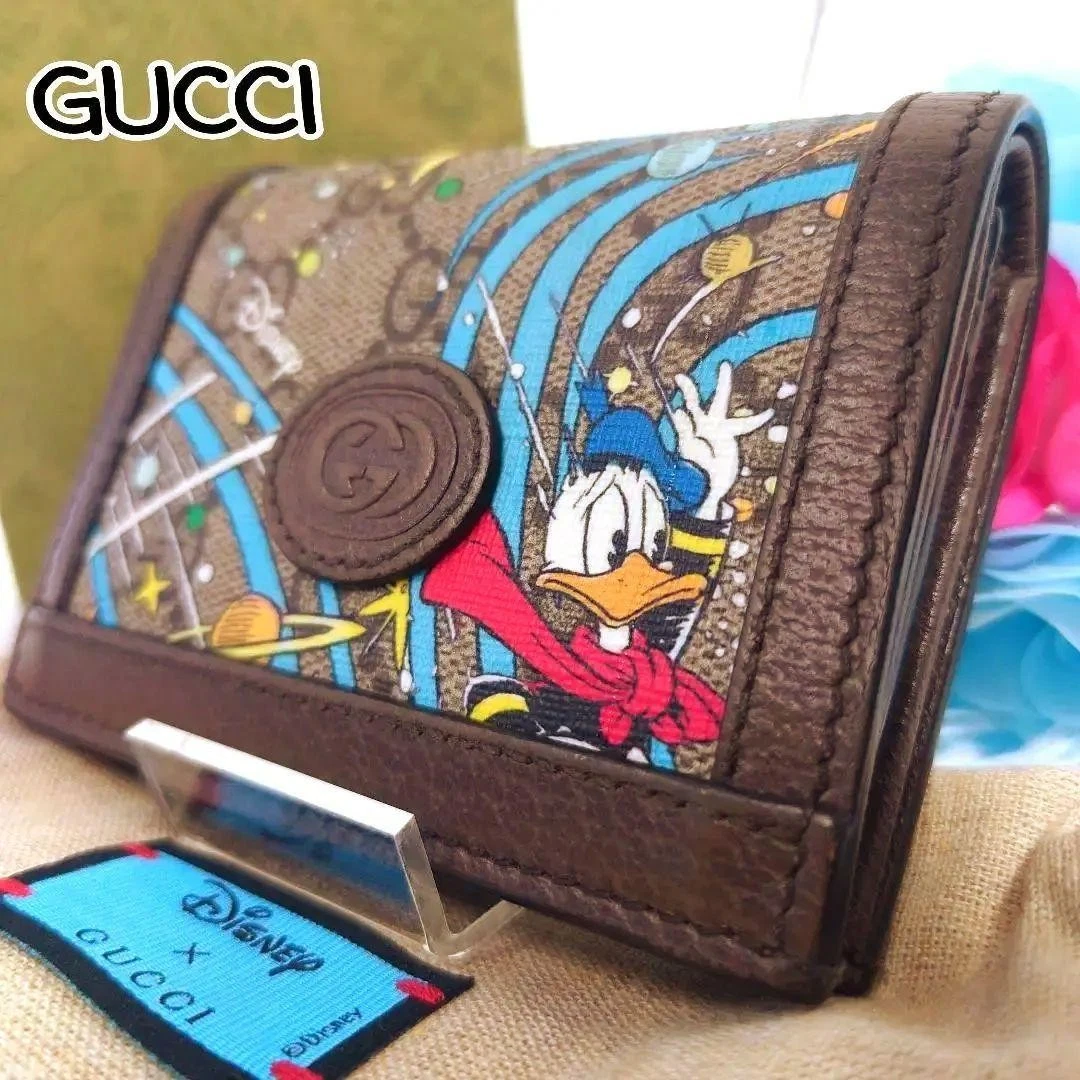 Portefeuille Gucci Disney deux plis GG Supreme Donald