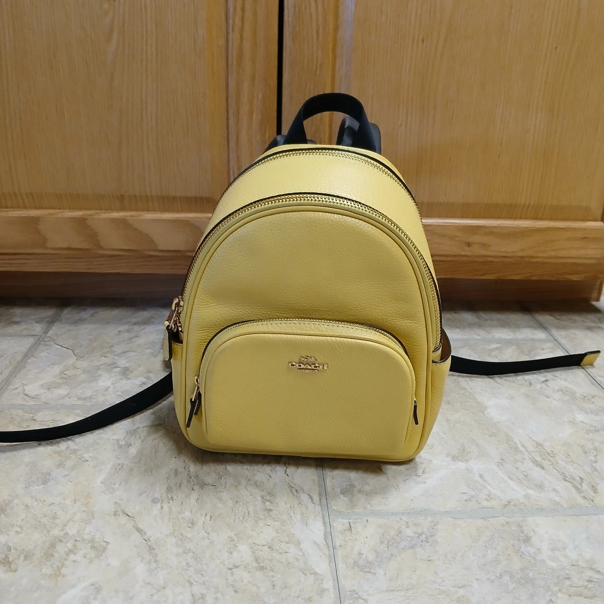 bright yellow coach backpack Court In Signature Canvas Refined pebble leather Inside zip and multifunction pockets Double zip closure fabric lining Handle with 2 1/4 drop Outside zip pocket Adjustable shoulder straps 10 3/4 (L) x 12 1/2 (H) x 4 3/4 (W) Style No. Coach Yellow Backpack - Bright