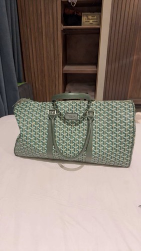 Goyard-style travel/duffle bag in green with the classic patterned design.