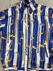 Women's blue and white striped jacket with repeated yellow golf club print and black zipper closure.