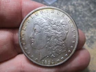 1894 O MORGAN SILVER DOLLAR IN ABOUT UNCIRCULATED CONDITION