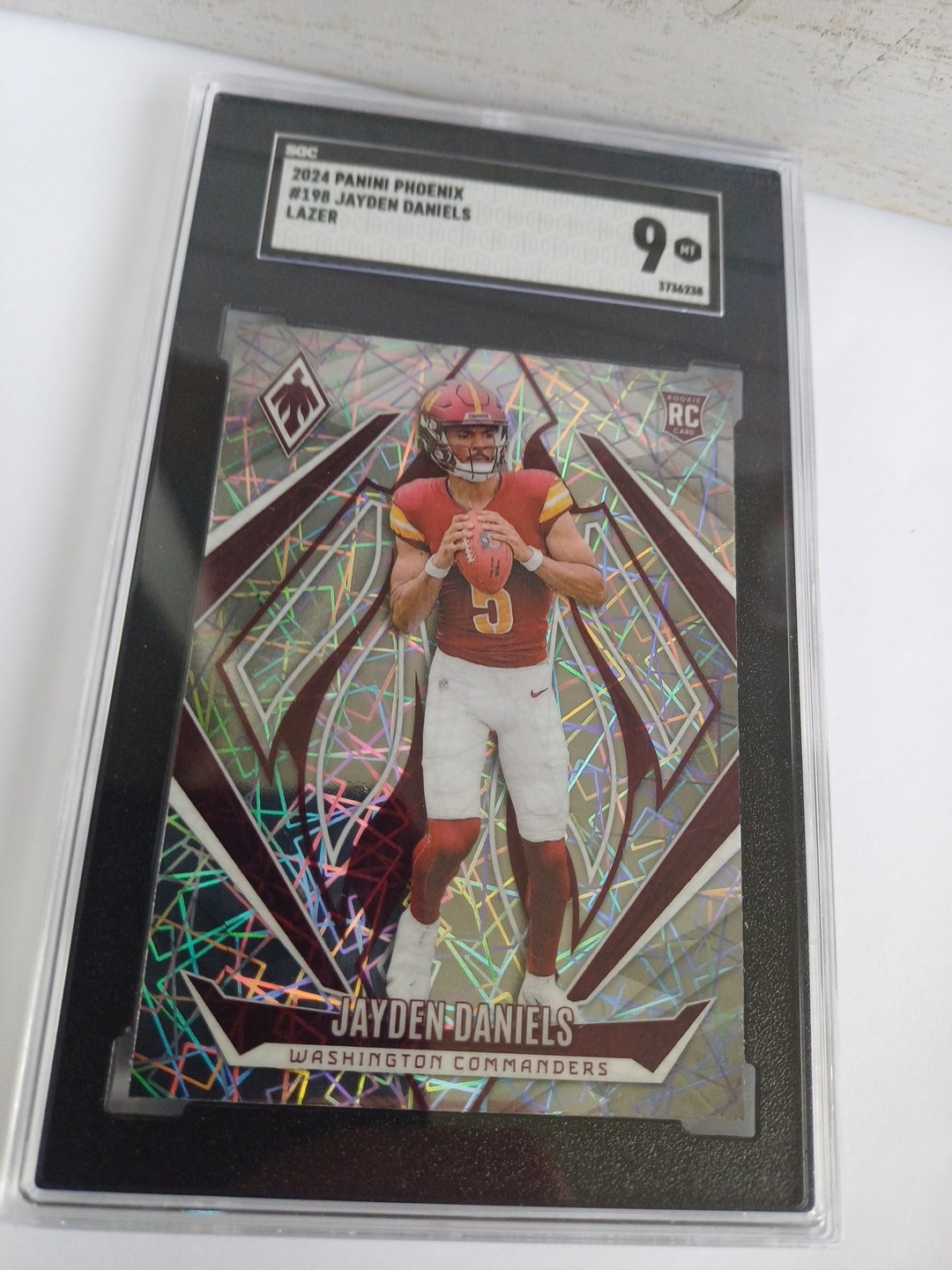 2024 Panini Phoenix - Rookies Jayden Daniels #198 Lazer (RC) SGC 9 Commanders