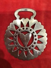 A stamped brass. Late Victorian, with lovely harness wear patina.