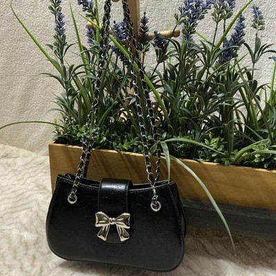 This is a small black faux leather crossbody bag with a silver-tone chain strap