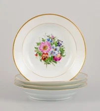 Bing & Grøndahl, four deep plates with flowers and gold decoration.