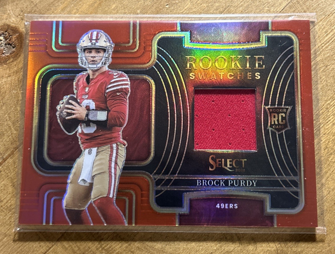 2022 Panini Select - Rookie Swatches Brock Purdy #RSW-17 Red Prizm (MEM, RC)