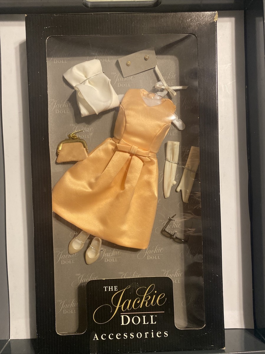 peach dress with gold accessories Franklin Kennedy The Jackie Doll and a clutch for