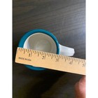 Teal green ceramic coffee mug with white ribbed bee, shown beside a wooden ruler measuring 3 inches tall.