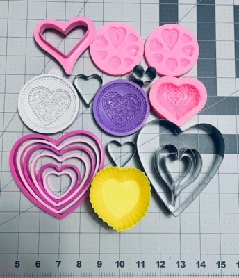 lot of 24 heart shaped cookie cutters, silicone molds, and cupcake liners 