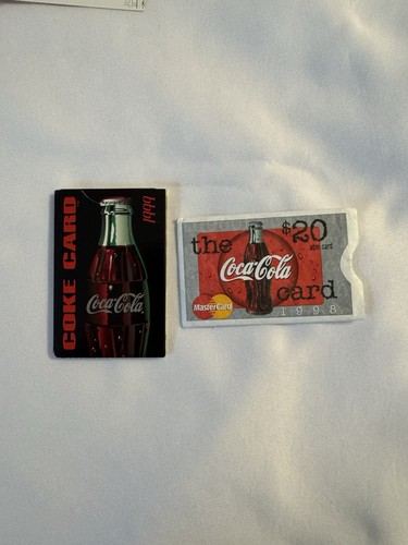 Two Coke ATM Cards With Sleeves and Discount Booklet