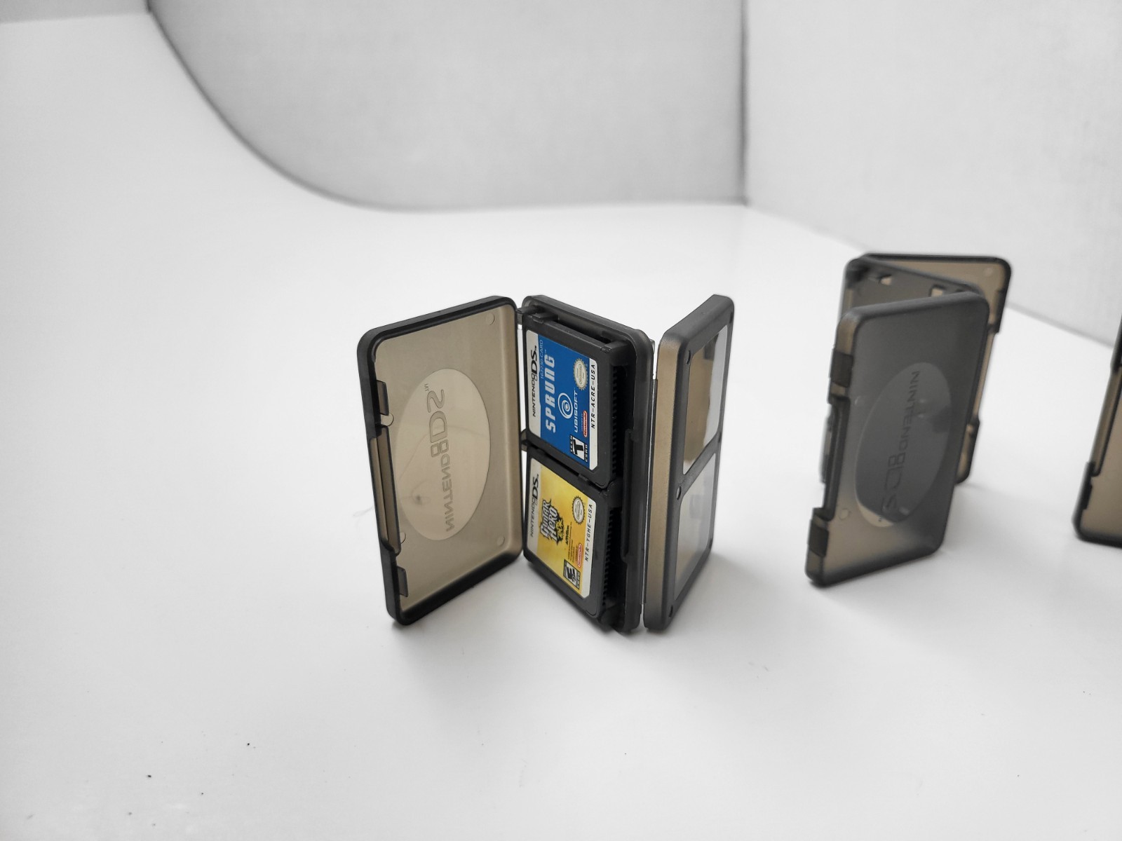 3 NEW OFFICIAL NINTENDO DS CLEAR BLACK 4 GAME CARTRIDGE CASE HOLDER 12 TOTAL 18N