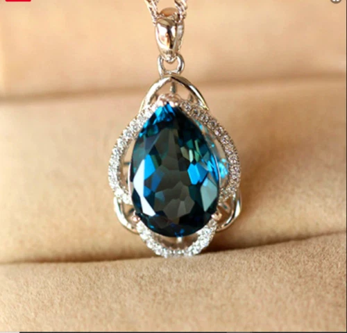 Colgante halo topacio azul Londres corte pera de 2,8 quilates acabado oro blanco 14k cadena gratis Foto 2 de 4