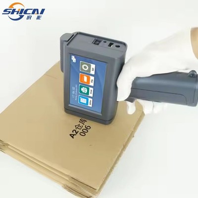 Handheld inkjet printer prints text batch number barcode QR code on cardboardbox