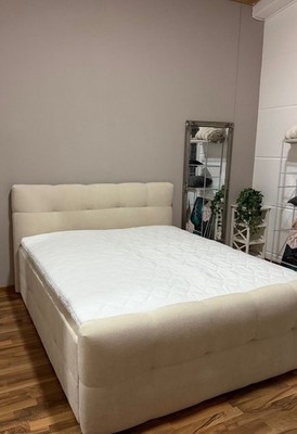 Beige upholstered bed, 180x220 cm, modern and elegant design.