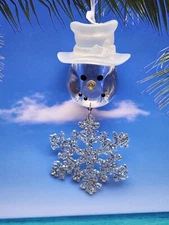 Acrylic snowman head with a sparkling snowflake ornament