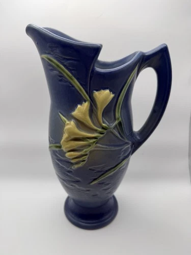 A blue matte glaze Roseville Freesia art pottery vase.