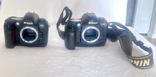 TWO Nikon D100 Camera Bodies, one battery AS is. Working condition is unknown.