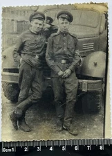 two young guys in military uniform near the car smoking, cute soldiers Old Photo