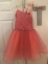 girls dance pink ballet dress with pink flowers on shoulder. Pink tulle 