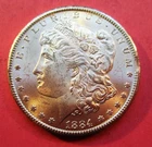 1884-CC MORGAN SILVER DOLLAR. UNCIRCULATED. HIGH GRADE.