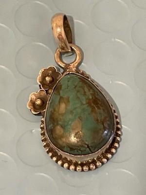 Sterling and Turquoise Pendant With 2 Flowers On Side Measures  1  1/2 Inch