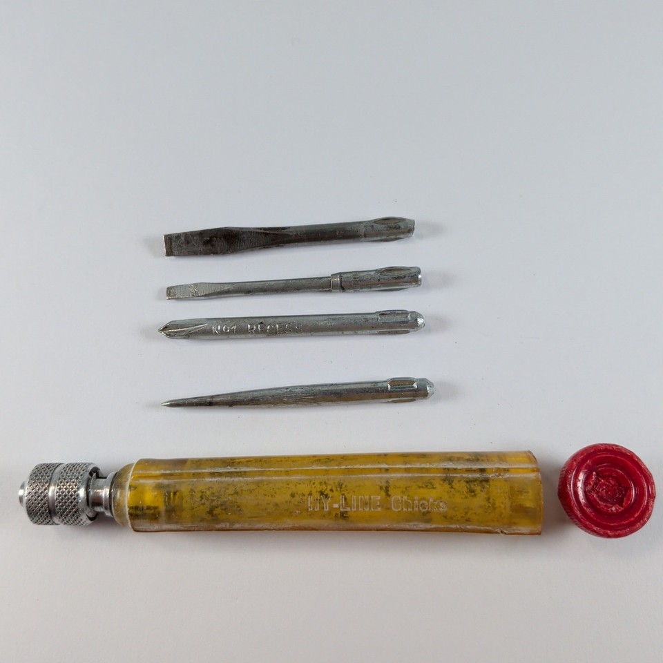 A tiny 2-inch pocket screwdriver set with flat, Phillips, awl, and blade — a satisfying vintage mini-tool that fits on a keychain.
