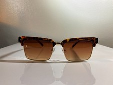 Unisex, tortoise shell gold wire frame sunglasses with brown gradient lenses.