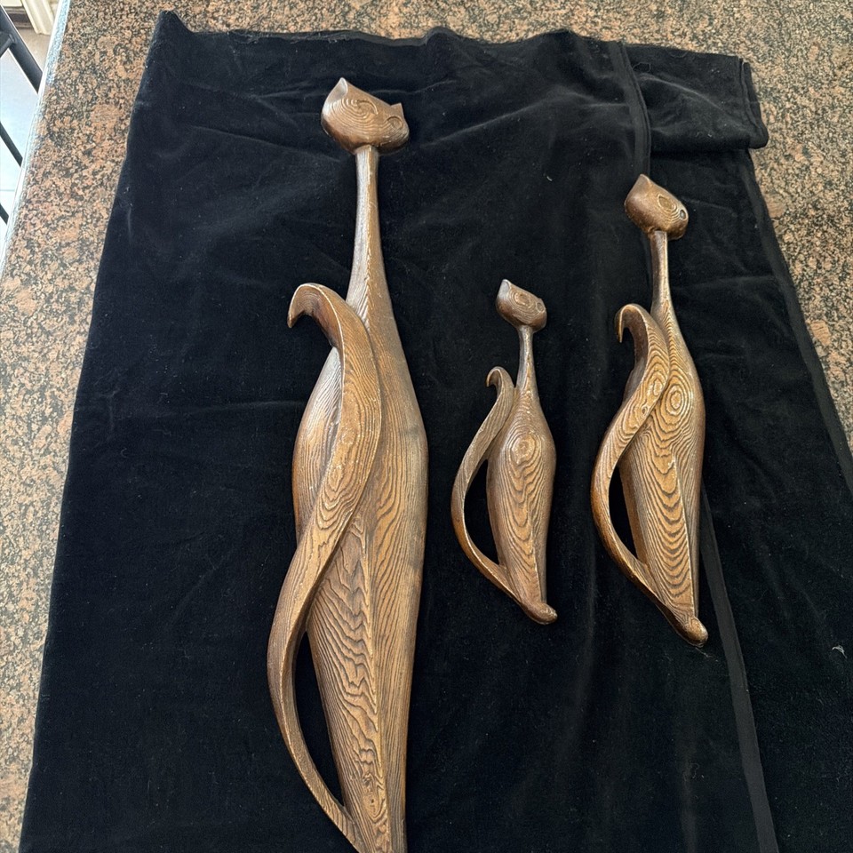 A genuine trio of Sexton-made mid-century Siamese cat wall plaques with woodgrain texture — the kind of retro wall art that stops visitors in their tracks.
