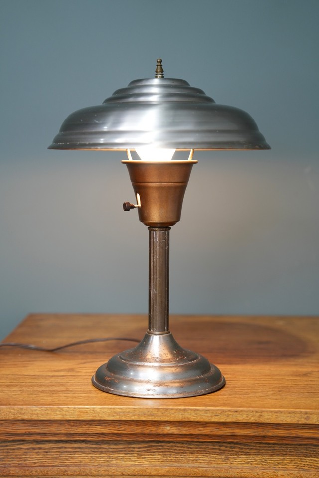 1950s atomic saucer UFO desk lamp in metal — the flying saucer silhouette is pure Atomic Age fantasy and impossibly cool on a desk.