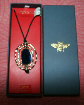 NIB 32'' cord + 3'' gold toned metal blue stone reversible spinning oval pendant.