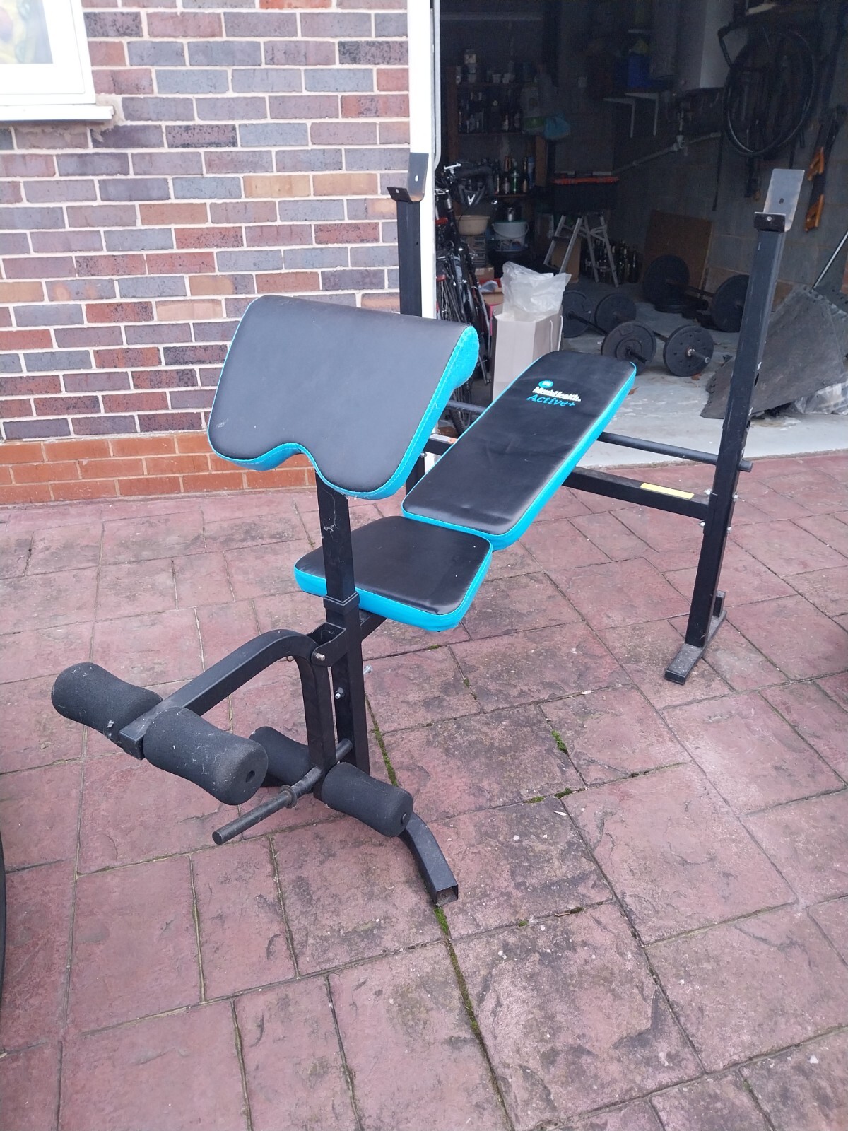 Adjustable bench press, weights, leg extension and preacher curl