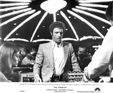 Lauren Hutton watches James Caan at the table from the film The Ga- Old Photo