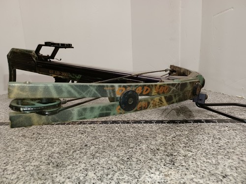 Camouflage Barnett QUAD-300 system 4 crossbow with black and green limbs, orange “BROAD 400” text, and dual cams.
