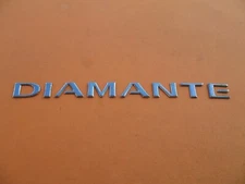 02 03 MITSUBISHI DIAMANTE REAR EMBLEM LOGO BADGE SIGN SYMBOL DECAL USED A26395