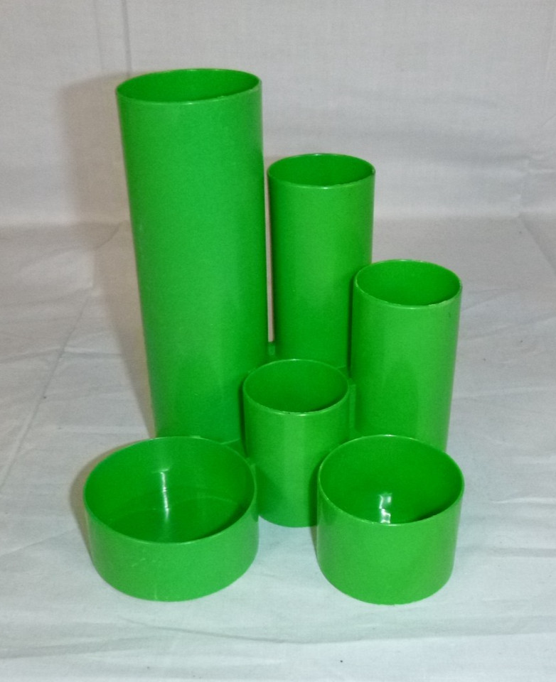 A groovy 1970s mod green tube pencil holder that looks like a prop from a retro sci-fi set — pure funky desk personality.