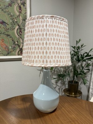 pleated lampshade atop a smooth, pale blue ceramic base Ballard Design