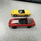 Two vintage Matchbox Chevy Corvette models - red (1984) and yellow (1987)