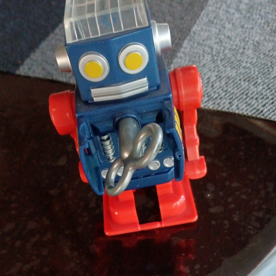 A wind-up walking tin robot that ALSO sharpens your pencils — vintage Japanese kitsch engineering at its most absurdly delightful.