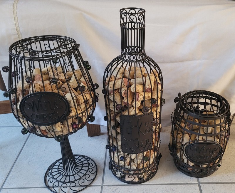 (3) DIFFERENT METAL RUSTIC CAGE CORK HOLDERS W/MARBLE GRAPE DECOR AROUND. 