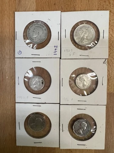 A collection of Canadian coins.  All are silver except the 5 cent pieces