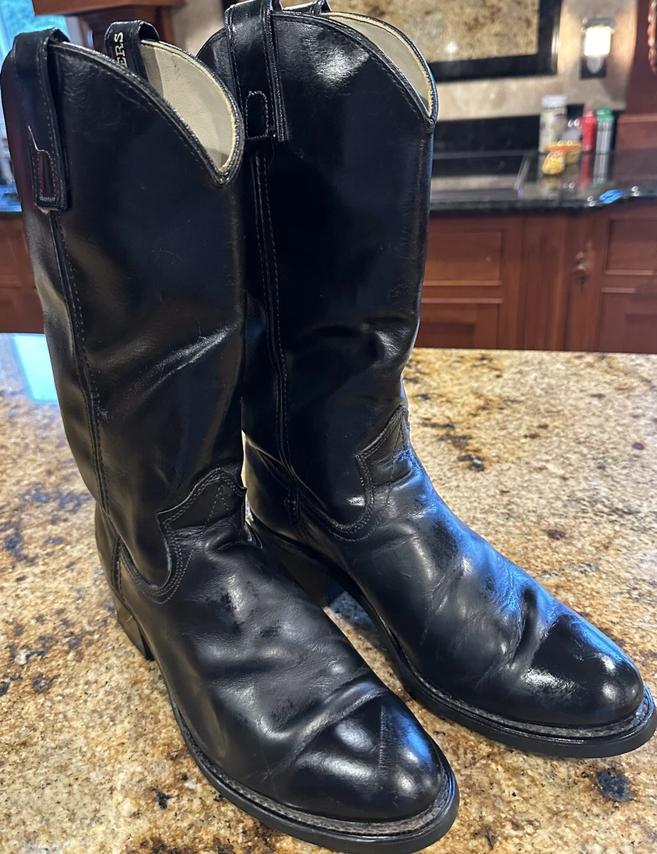 Black leather Sheplers cowboy boots with oil-resistant soles, perfect for work and outdoor activities