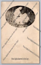 Antique RPPC woman sitting in field in profile Real Photo Postcard 