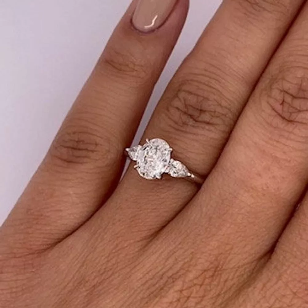 Oval trilogy engagement ring sale